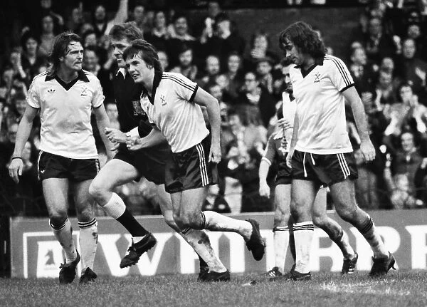 Terry Bullivant celebrates a goal for Fulham with George Best