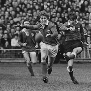 Barry John kicks under pressure from Fergus Slattery - 1971 Five Nations