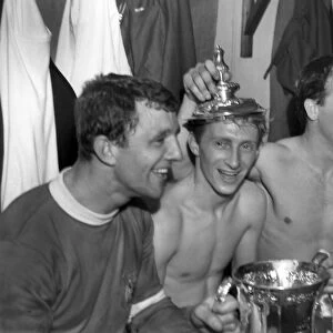 Bobby Charlton has a cigarette as his teammates celebrate after winning the FA Cup
