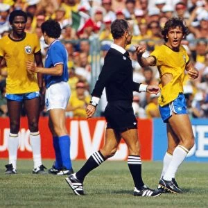 Brazils Zico remonstrates with the referee after his shirt is ripped at the 1982 World Cup