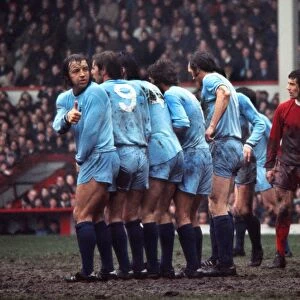 Coventrys Ernie Hunts checks his position in the wall during a game at Anfield in 1971 / 2