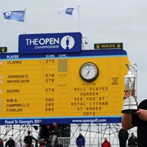 Darren Clarke - the 2011 Open Champion in front of the final scoreboard