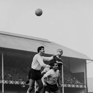 Dave Mackay and Maurice Norman jump for Spurs against Evertons Alex Young