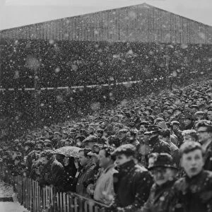 Fans at Old Trafford watch the action in the snow during the 1954 / 5 FA Cup