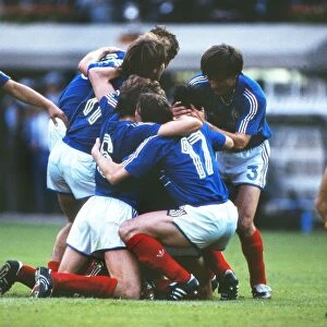 France captain Michel Platini is mobbed by team mates after scoring his sides opening goal in the Euro 84 final