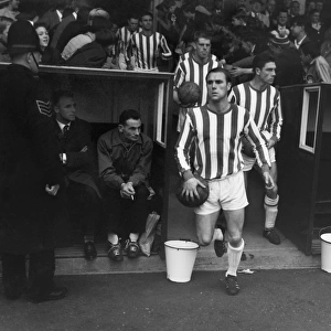 Huddersfield Town captain Ray Wilson leads his side out at Leeds Road in 1962