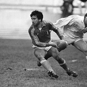 Italys Alessandro Ghini under pressure from Brian Moore of England B in 1985