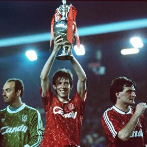 Liverpools Gary Ablett holds the League Championship trophy afloft in 1990