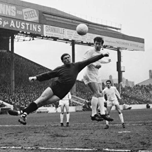 Manchester City goalkeeper Alan Ogley attempts to punch clear from Ipswichs Gerry Baker