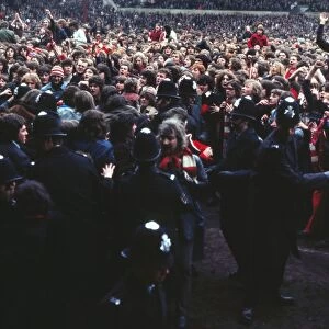 Manchester United fans invade the pitch after Bobby Charltons final home game for the club