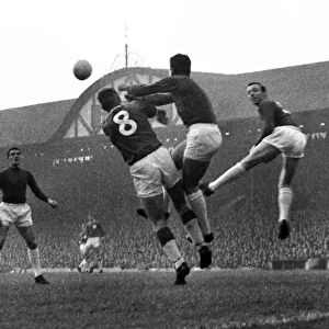 Manchester United goalkeeper Patrick Dunne punches the ball clear at Anfield in 1964 / 5