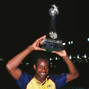 Michael Thomas celebrates with the league trophy after winning the 1988 / 9 title