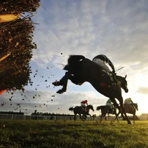 The riders clear the last hurdle of the 15: 05 Stan James International Hurdle at Cheltenham racecourse