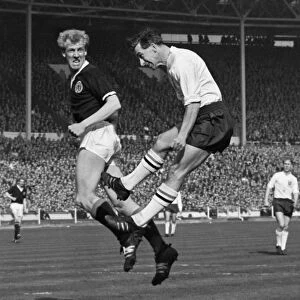 Scotlands Ian Ure and Englands Bryan Douglas jump for the ball - 1963 British Home Championship