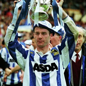 Sheffield Wednesday goalscorer John Sheridan holds aloft the League Cup trophy in 1991