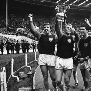 West Ham players Ken Brown, Bobby Moore and Peter Brabrook parade the FA Cup after victory in 1964