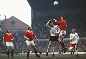 Soccer Collection: Arnie Sidebottom and Bill Dearden jump for the ball at Old Trafford in 1973
