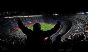 An Arsenal fan sings and dances in the top tier of the Nou Camp before the game against Barcelona