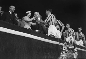 Aston Villa captain Johnny Dixon receives the FA Cup from the Queen in 1957