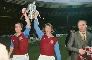 Aston Villas Ian Ross and Ian Chico Hamilton parade the League Cup with manager Ron Saunders in 1975
