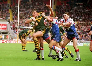 Australias Paul Harragon is tackled by several Great Britain defenders