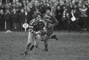 A bloodied JPR Williams runs for Bridgend against the All Blacks in 1978