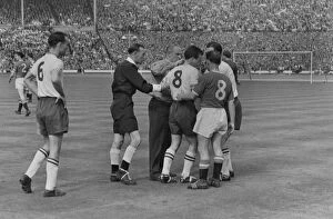 1958 FA Cup Final - Bolton Wanderers 2 Manchester United 0 Collection: Boltons Dennis Stevens is helped to his feet after lying injured - 1958 FA Cup Final