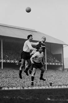Tottenham Collection: Dave Mackay and Maurice Norman jump for Spurs against Evertons Alex Young