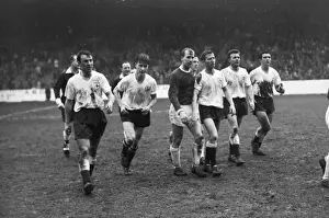 A dejected Bobby Charlton walks off the field with the Spurs players after the 1962 FA Cup semi-final