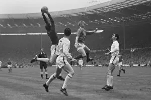1963 FA Cup Final - Manchester United 3 Leicester City 1 Collection: Denis Law challenges Gordon Banks during the 1963 FA Cup Final