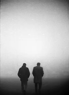 England manager Don Revie and FA Secretary Ted Coker walk off the pitch in the fog after the game against Czechoslovakia is abandoned in 1975