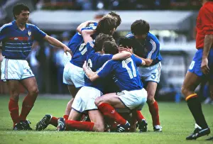 France captain Michel Platini is mobbed by team mates after scoring his sides opening goal in the Euro 84 final