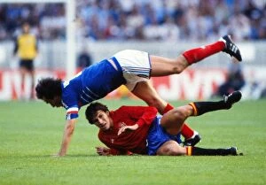 Images Dated 16th January 2012: Frances Michel Platini is tackled by Spains Victor Munoz in the final of Euro 84