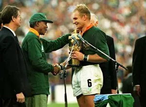 Rugby Collection: Francois Pienaar receives the Webb Ellis Cup from Nelson Mandela