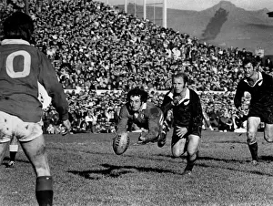 Gareth Edwards passes to Barry John during the second Lions test against the All Blacks in 1971 (crop)