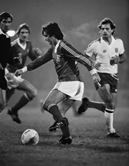George Best on the ball for Ipswich while Englands Ray Wilkins looks on