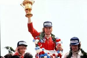 Motorsport Collection: James Hunt lifts the trophy after winning the 1976 British Grand Prix