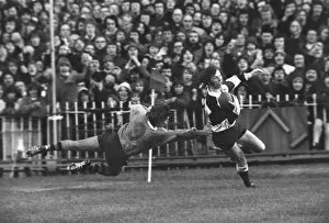 Images Dated 19th February 2009: JJ Williams evades a tackle to score for the Barbarians in 1976