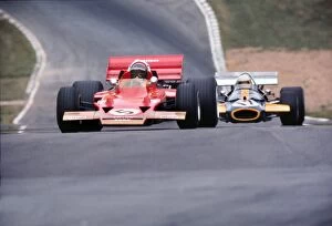 Motorsport Collection: Jochen Rindt and Jack Brabham approach Druids at the 1970 British Grand Prix at Brands Hatch