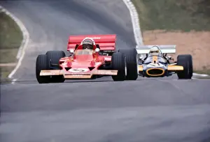 Jochen Rindt and Jack Brabham approach Druids at the 1970 British Grand Prix at Brands Hatch