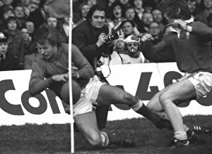 Images Dated 17th June 2006: JPR Williams makes his famous shoulder-barge tackle on Jean-Francois Gourdon - 1976 Five Nations
