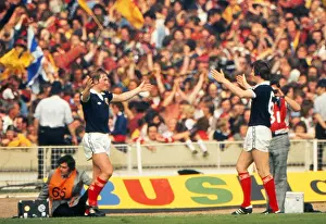 Kenny Dalglish celebrates his goal with Bruce Rioch in front of the Scotland fans at Wembley - 1977 British Home Championship