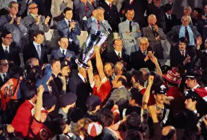 Liverpool captain Emlyn Hughes lifts the European Cup in 1977