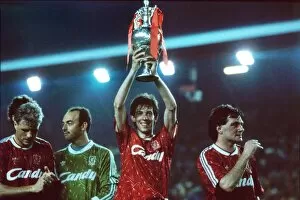 Images Dated 1st May 1990: Liverpools Gary Ablett holds the League Championship trophy afloft in 1990
