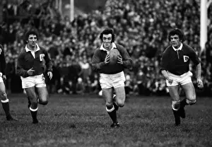 Llanellis Phil Bennett on the ball, supported by Selwyn Williams and Phil May