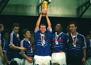 Man of the Match Zinedine Zidane holds aloft the World Cup trophy