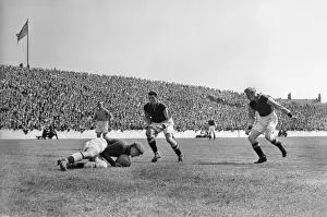 Manchester City goalkeepr Frank Swift falls on the ball as Aston Villa players move in