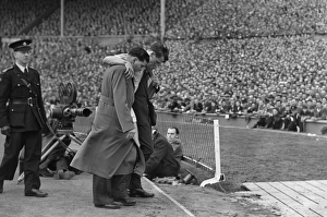 Manchester Citys Jimmy Meadows leaves the field with a knee injury in the 1955 FA Cup Final