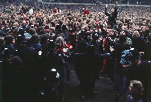 Images Dated 21st March 2011: Manchester United fans invade the pitch after Bobby Charltons final home game for the club