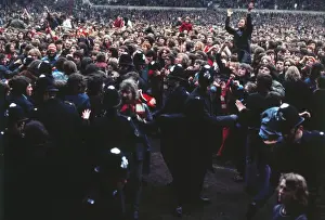 Manchester United fans invade the pitch after Bobby Charltons final home game for the club